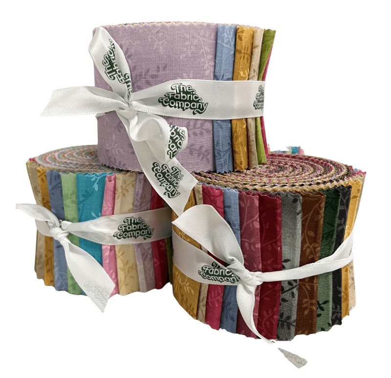 Stack of colorful fabric rolls tied with a white ribbon on a white background