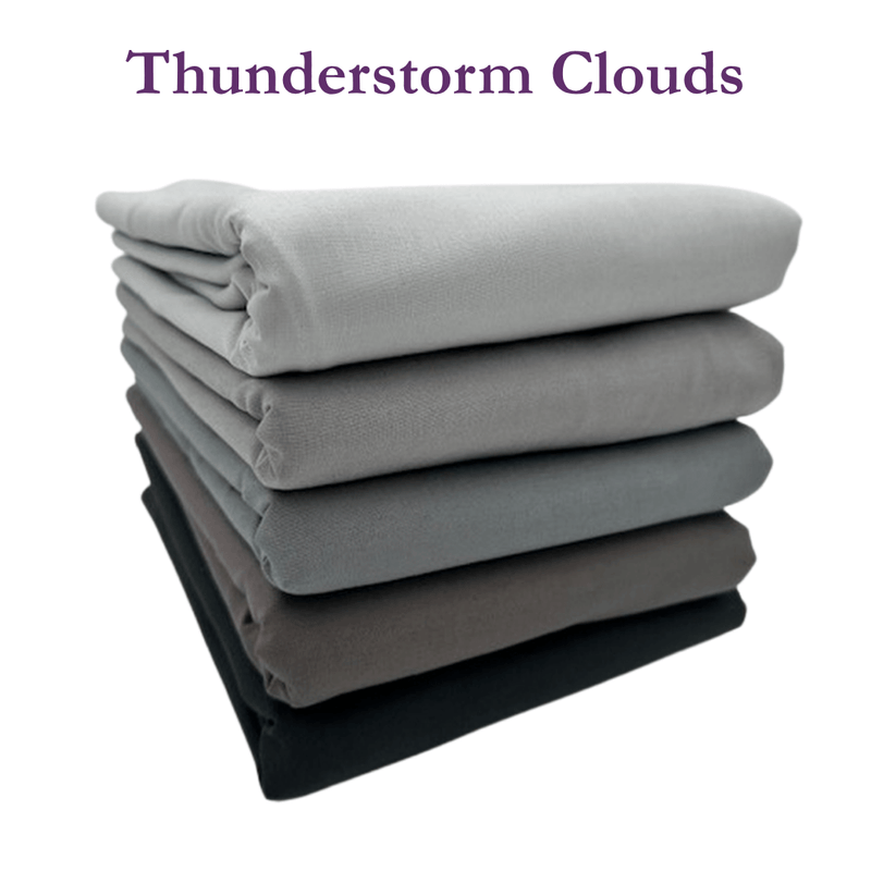 Stack of folded fabrics with 'Thunderstorm Clouds' text on a white background